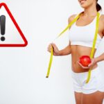 donna con mela e simbolo attenzione